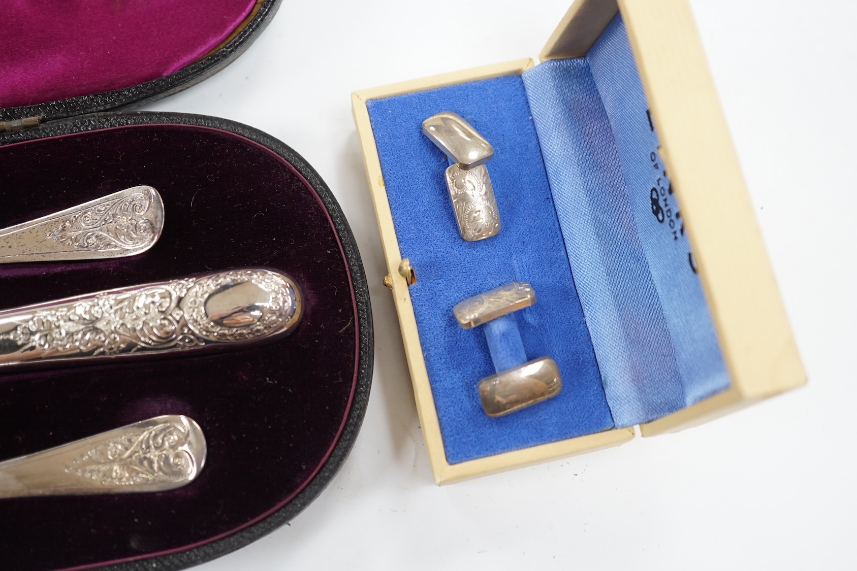 A late Victorian cased chased silver christening trio, London, 1897/90, together with a pair of engraved 925 cufflinks. Condition - fair